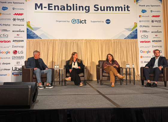 Glenda Sims from Deque on the main stage accompanied by 3 panelists.